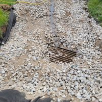 Grading restored to existing drain